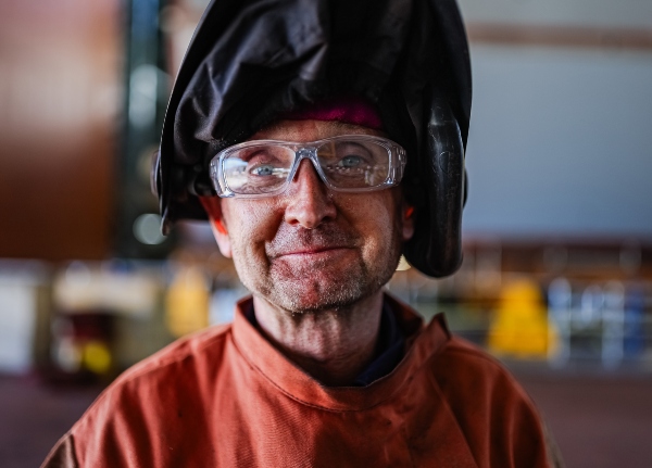 Male welder working at BAE Systems Australia’s Osborne Naval Shipyard.